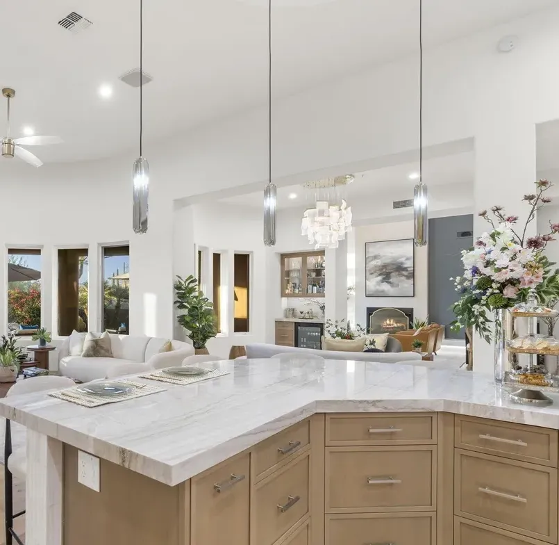 Kitchen with marble island, custom cabinetry, and dining area